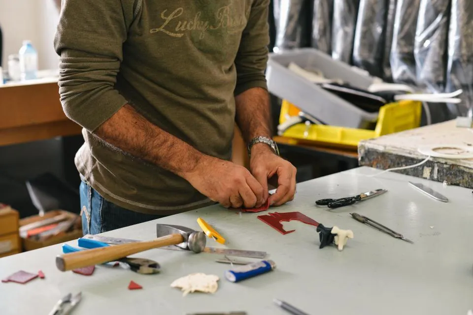 Technician assembling parts at a workbench