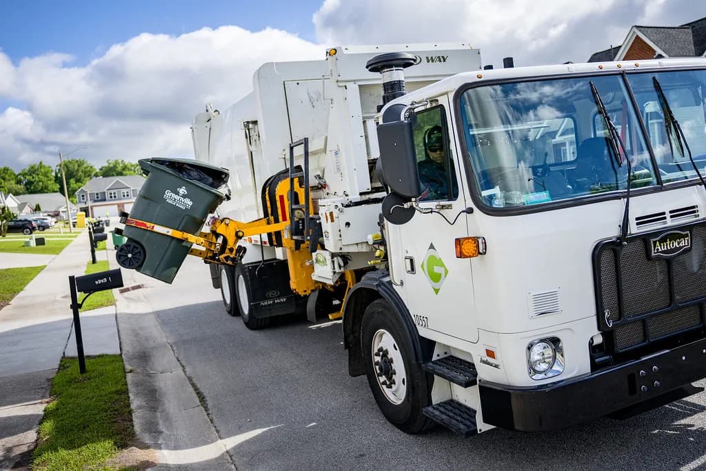Automated collection truck lifting a curbside cart