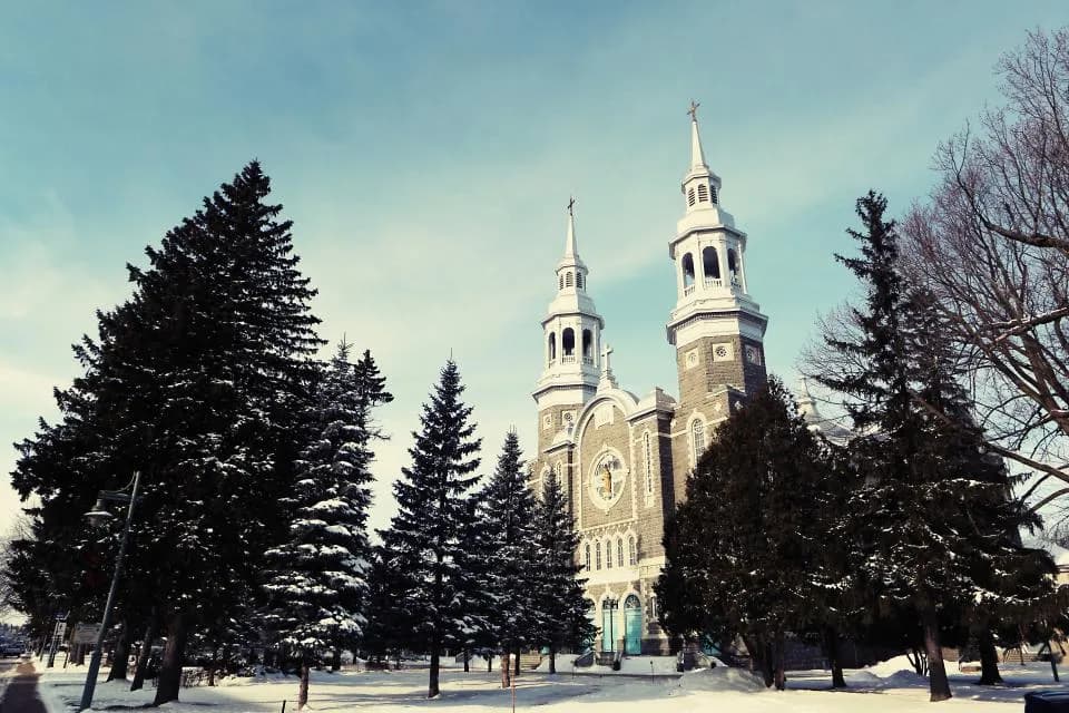 Church with twin steeples among evergreen trees