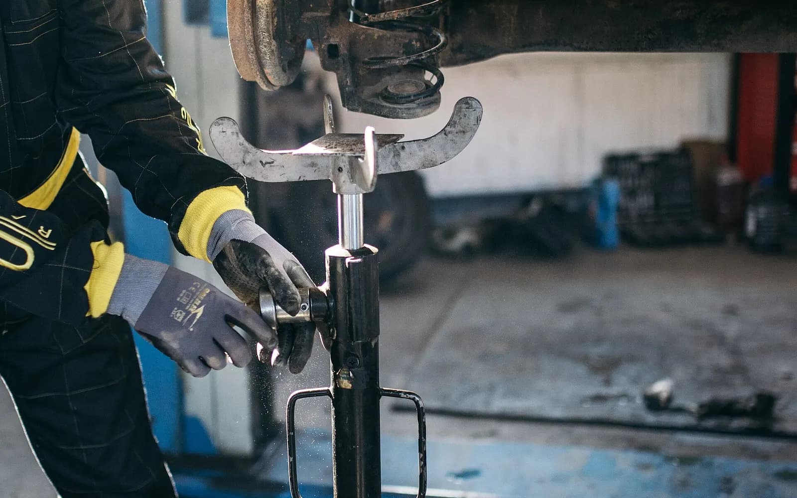 Vehicle service bay with technician at work